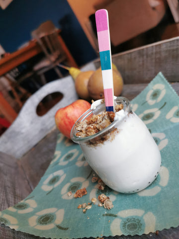 Kid-friendly granola served with greek yogurt in a glass jar with striped spoon