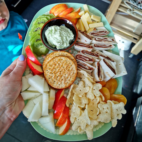 Children's Snack Platter with fruit, pesto dip, crackers, wraps with homemade chocolate spread