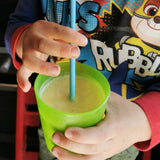 Child drinking Pineapple, Lime & Ginger Smoothie with a straw