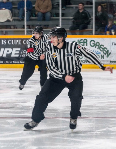 Linesman Nick Albinati skates up the ice during a hockey game in the BCHL