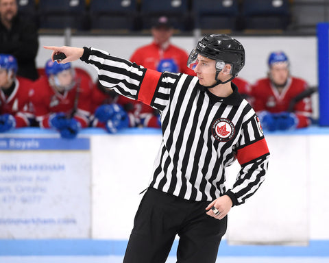 Referee Josh Schein points to a linesman during an Ontario Hockey Association game