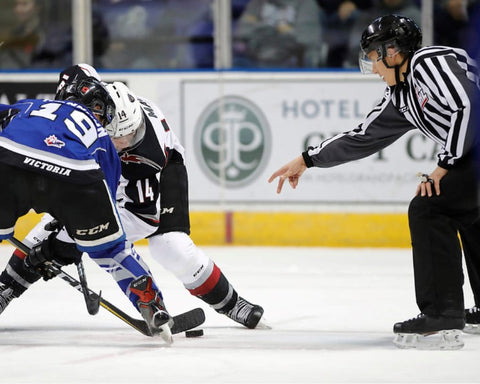 Linesman Liam Reid drops a puck during a WHL game between the Victoria Royal and Vancouver Giants