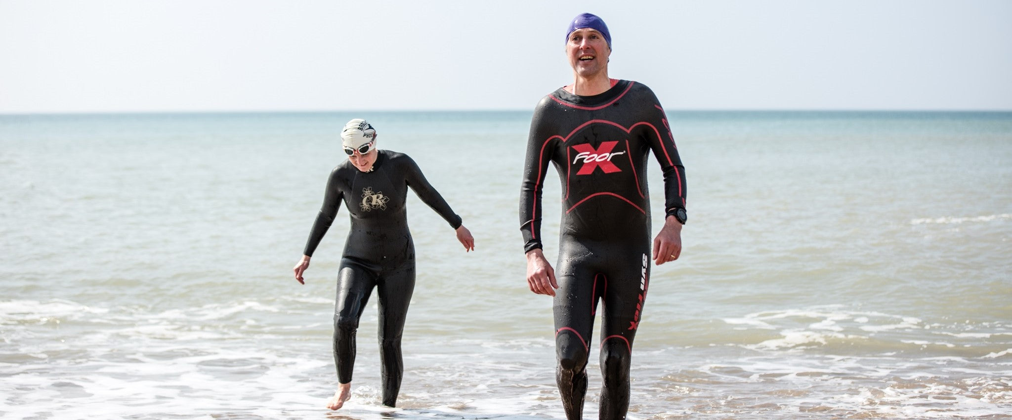 Two triathletes leave the sea