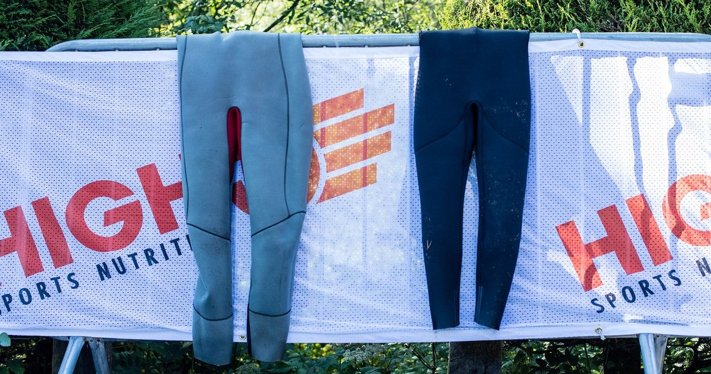 Two wetsuits hanging to dry