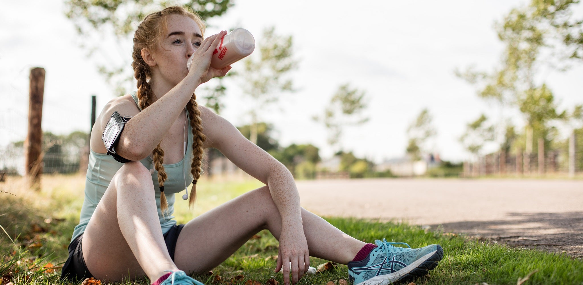 Woman resting and drinking Recovery Drink