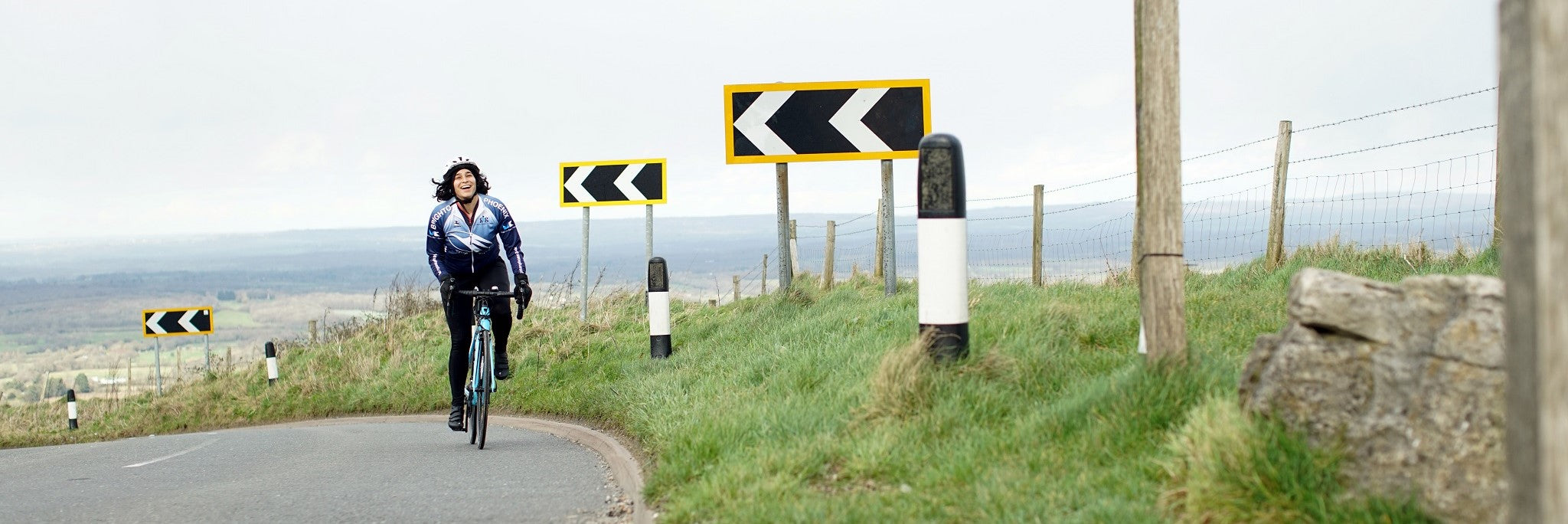 Woman cycling up a hill