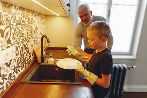 Father son washing dishes