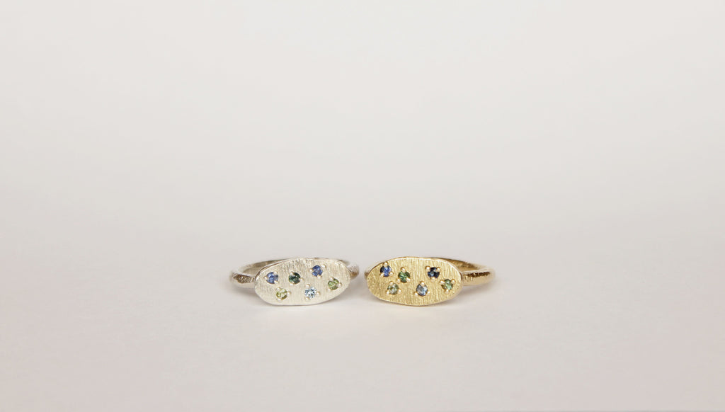 Silver oval ring with scattered sapphires
