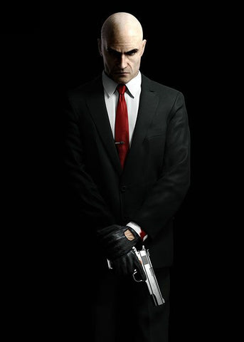 Hitman standing with a gun in his hands in black suit and red tie 