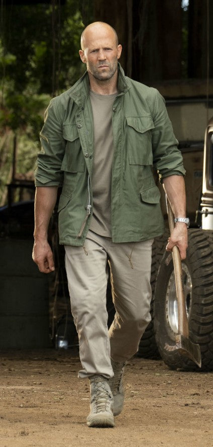 JASON STATHAM in green jacket holding an ax