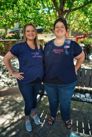 Two white women standing side by side demonstrating the fit of the breastfeeding tee