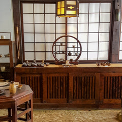 Japanese screen and shelving over packed earth floor at the Tatami Kiln