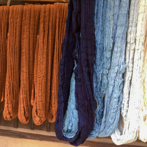 Persimmon and indigo yarns drying in the sun