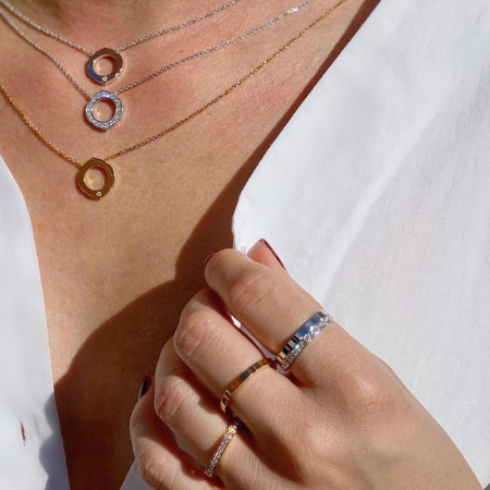 White, yellow and rose gold necklaces and layered stacking rings
