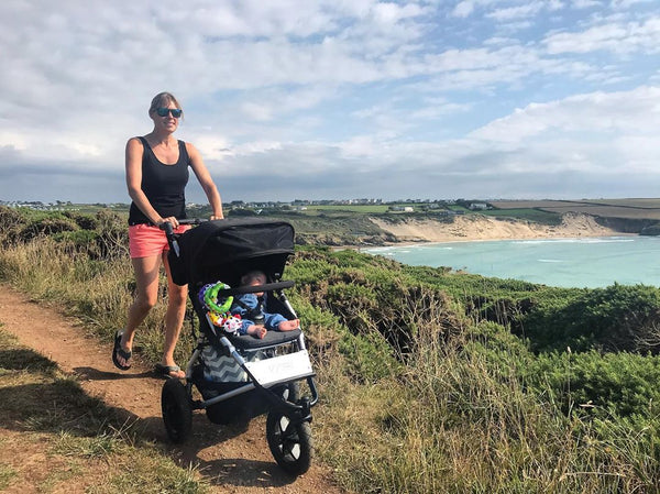 Squash Falconer with her baby in Mountain Buggy terrain on walking track