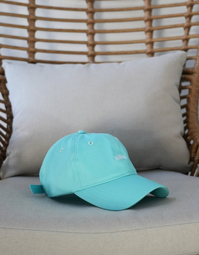 Crimson tavernorlando Aloha Dad hat in the colors light teal with the word aloha embroidered on the front
