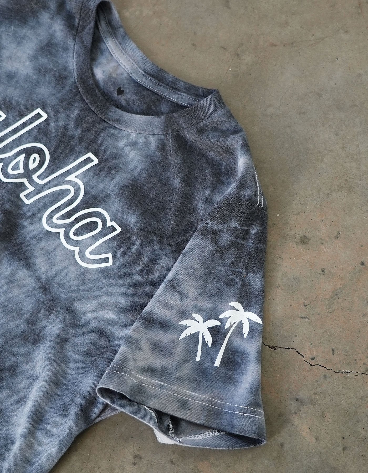 Crimson tavernorlando aloha tie die shirts that is black and grey tones and palm trees printed on the other sleeve