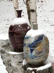 Two handthrown pottery vases outside in the snow