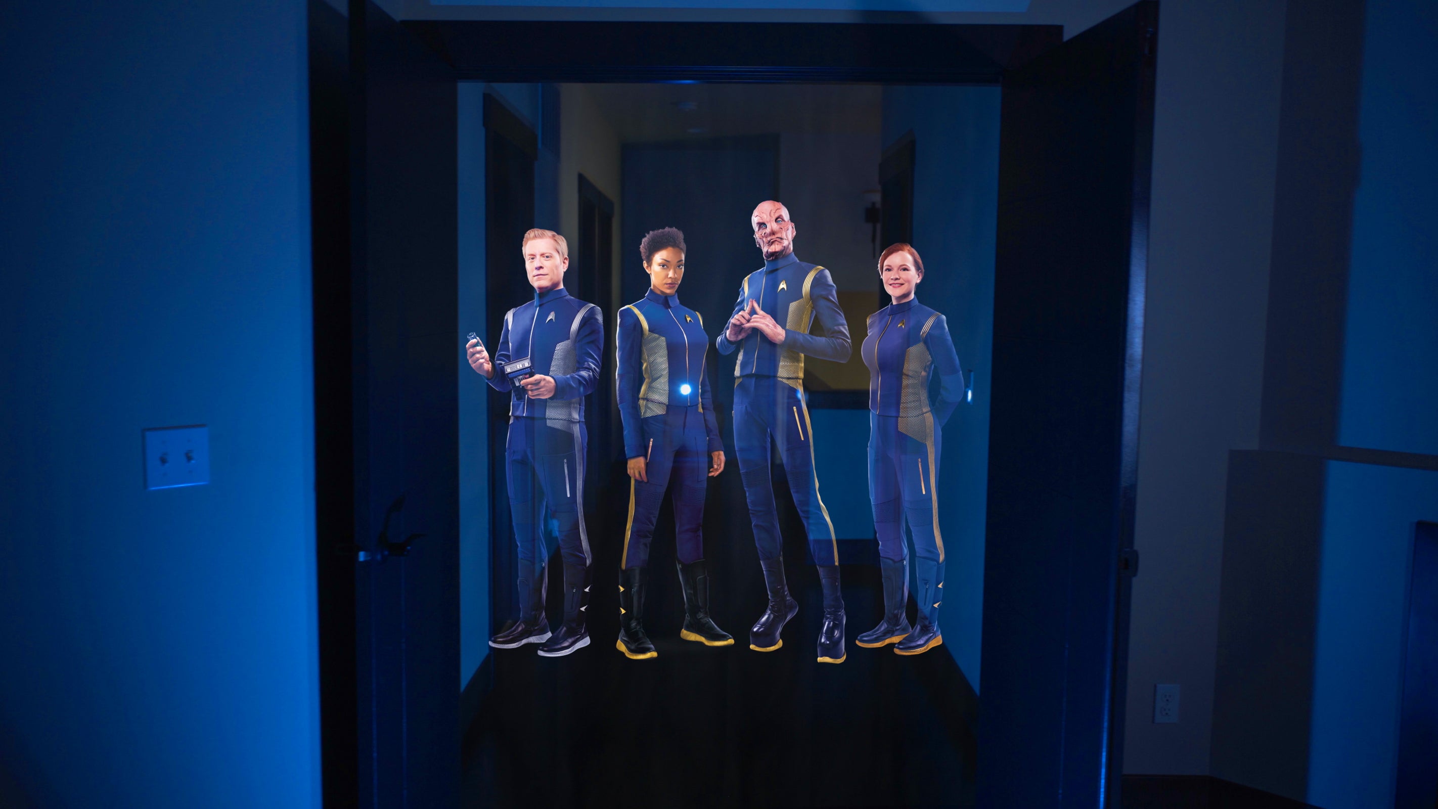 The crew from Discovery appears as a hologram-like illusion in your hallway