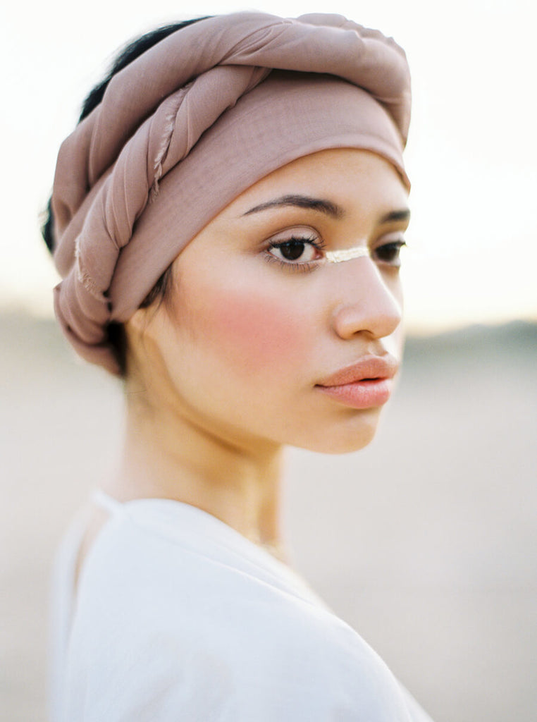 film image by erich mcvey of a gorgeous, delicate-featured, asian woman wearing a turban with beautiful soft pink cheeks and delicate light paint across her nose