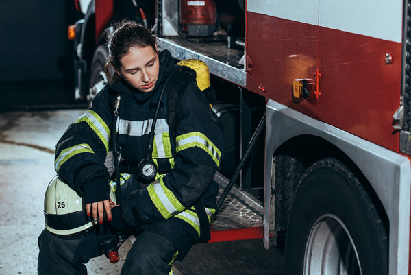 Electrolytes drink: A dehydrated fire fighter sits on the truck, exhausted