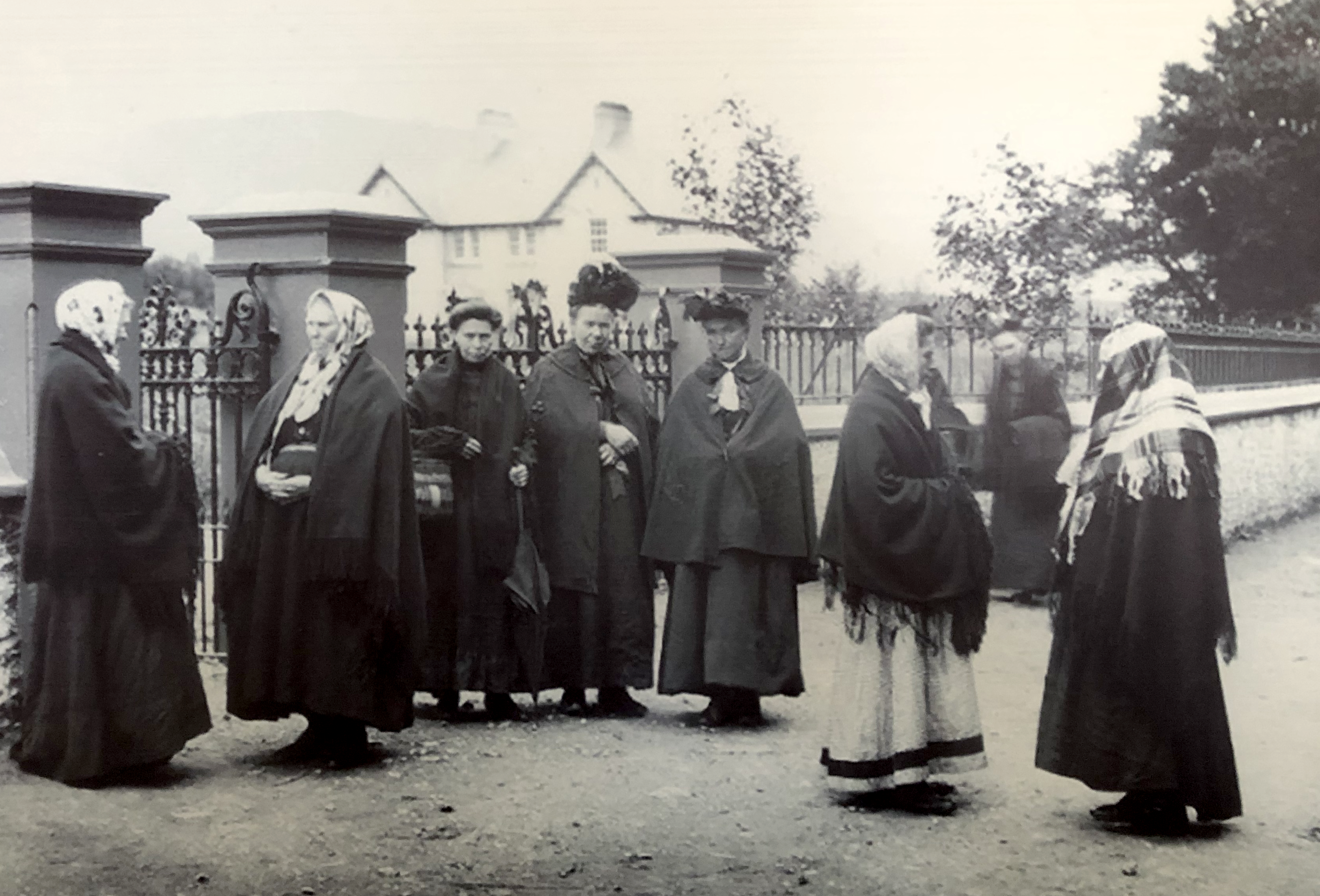 Irish women gathered wearing Tweed and wool capes