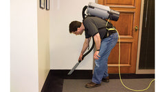 bent over vacuuming