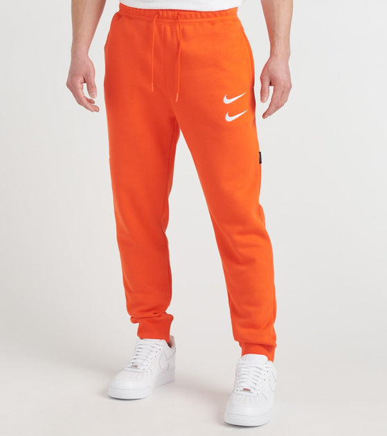 nike track pants orange