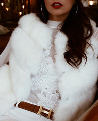 close up of girl wearing white lace shirt and a Furever vienna white faux fur vest