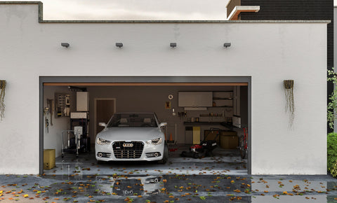 A garage flooded with leaves and water