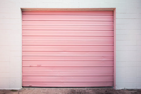 White house with a pink garage door