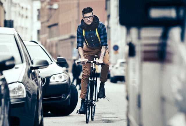 guy in a bike with stylish helmet around his neck