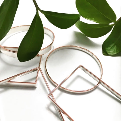 Picture of Claudine Moncion square and round bangles with green leaves around it