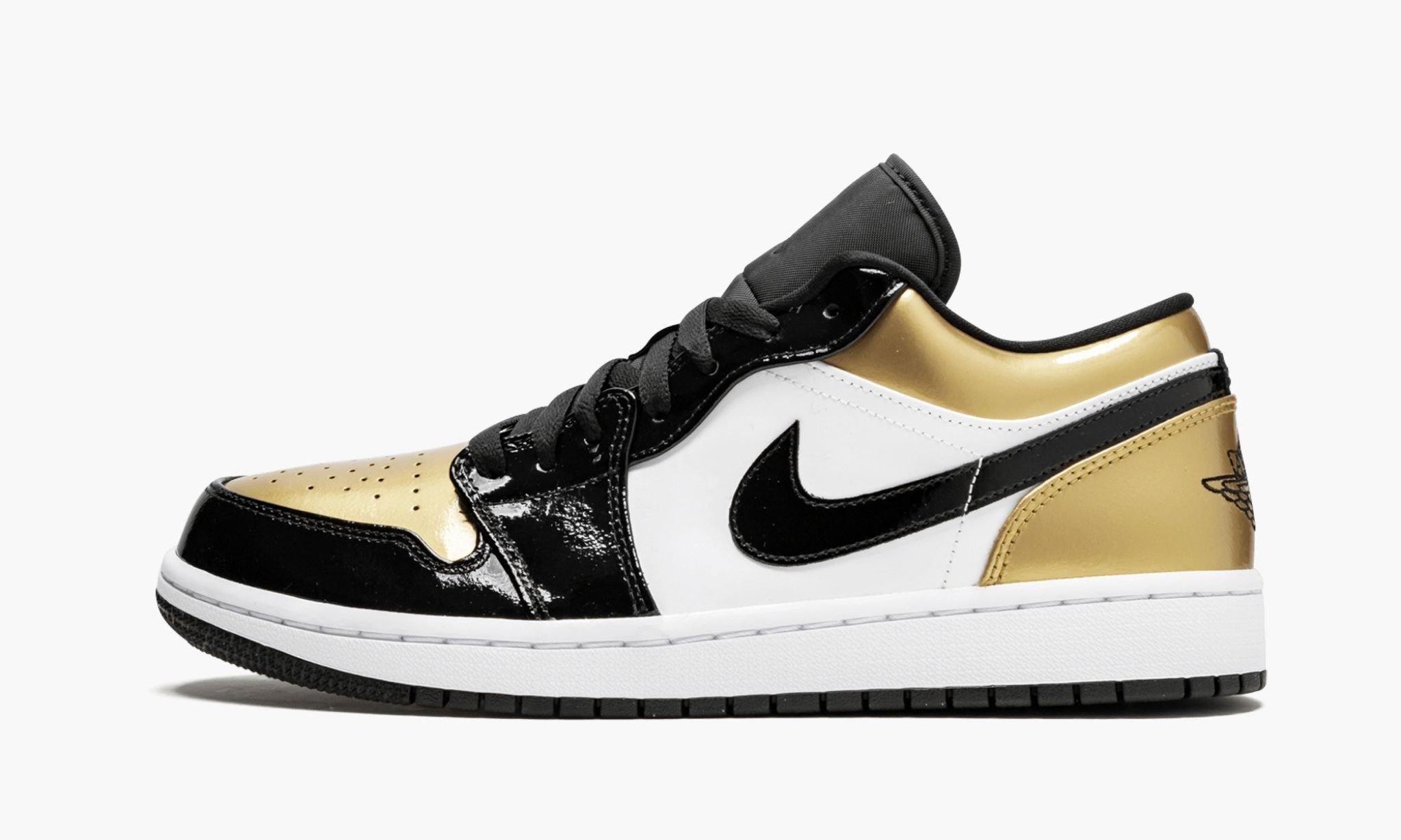 gold and white low top jordans