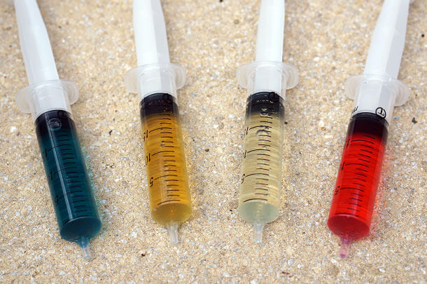 four syringes each filled with various types of mineral oil and dot fluid