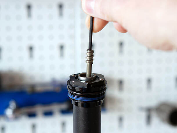 Removing the low speed compression needle from a RockShox Charger Damper with a 2.5mm hex wrench