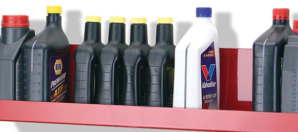 Bottles of oil and fluid on shelf