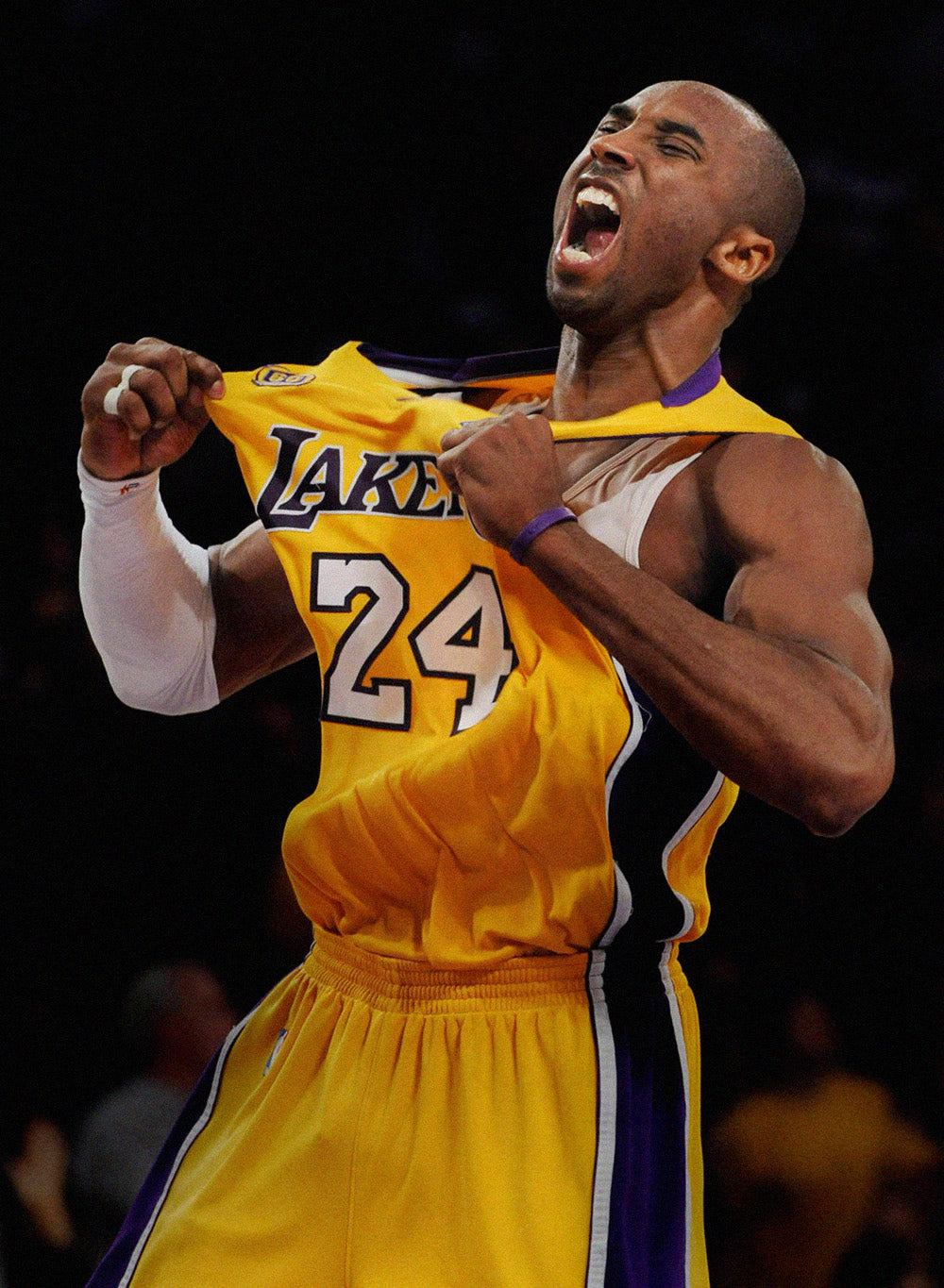 Photo of Kobe 'Bean' Bryant grabbing his yellow 24 Lakers jersey