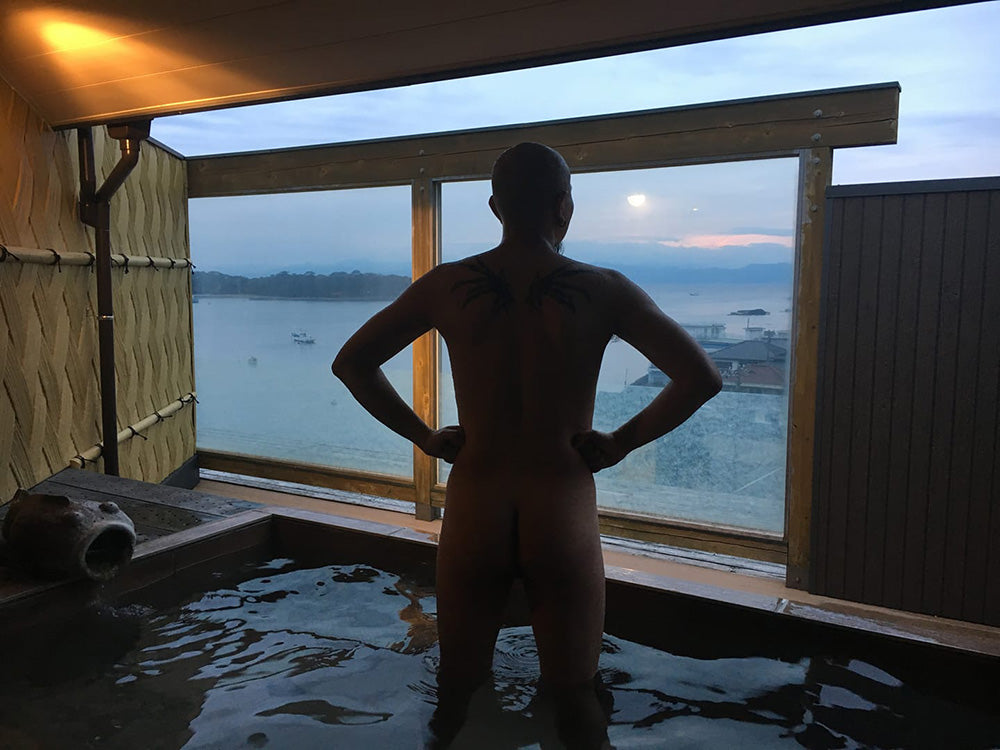 Cheeky Mike Magik at a Japanese onsen, taking in the sunset.