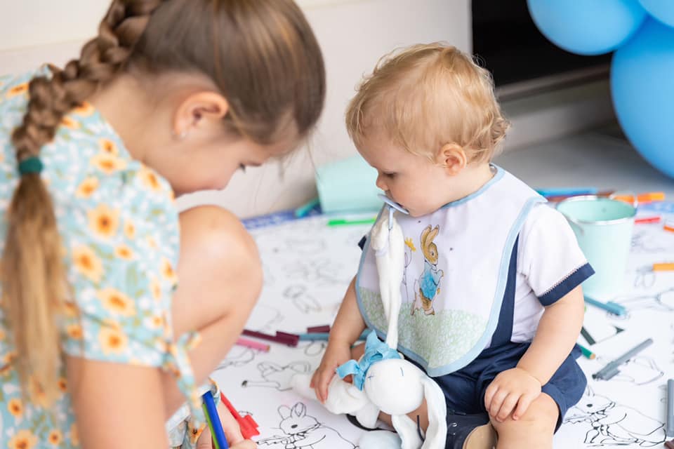 Children Gathered around giant Peter Rabbit floor colouring in page