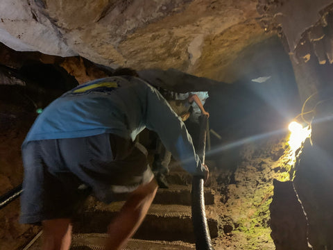 climbing through narrow passagways in tuckaleechee caverns, tennessee