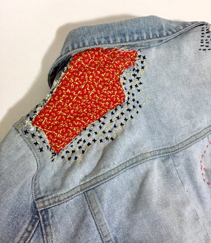 Visible mending on denim