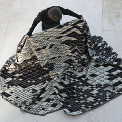 Nani Marquina Bouroullec Losanges Rug Black and White, woman unfolding