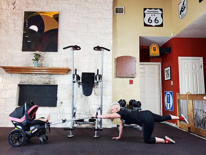 woman kneeling behind Dash Wagon preparing to exercise