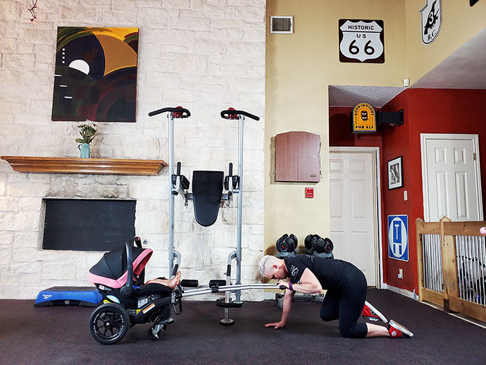 woman kneeling behind Dash Wagon exercising