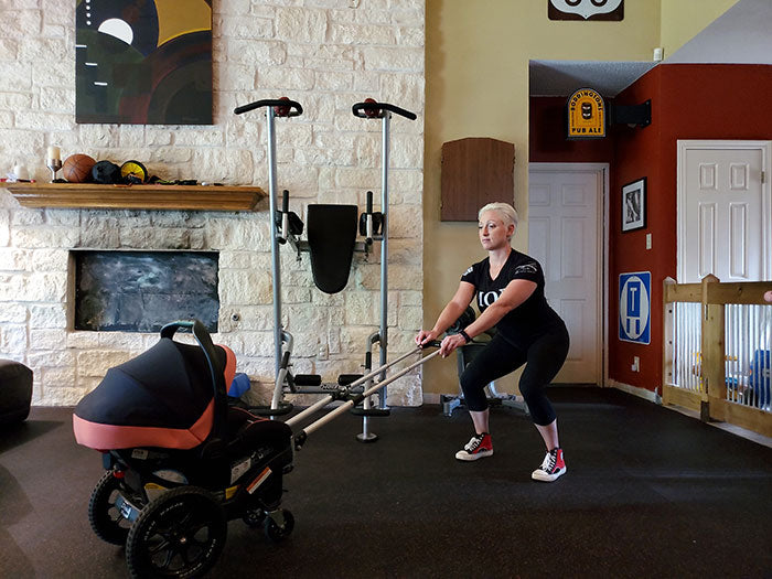woman performing squat exercise behind Dash Wagon