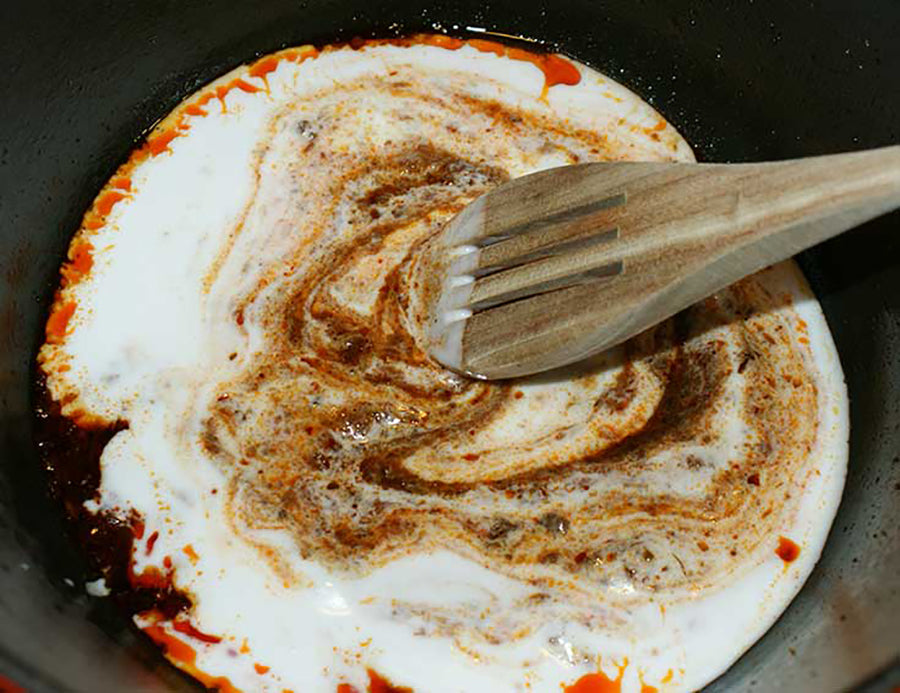 Add coconut milk to pan and stir