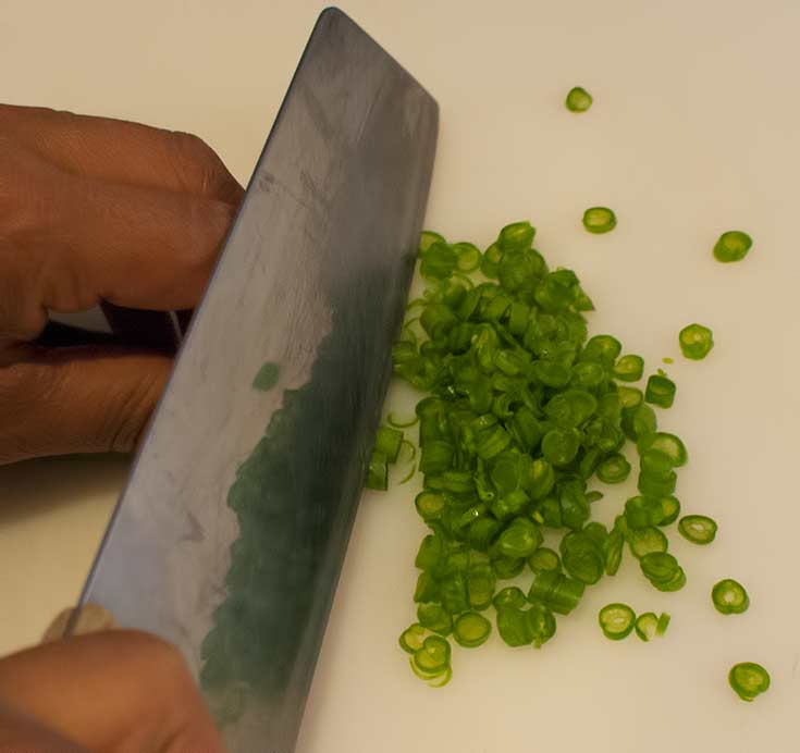 Chopping green beans for Thai fish cakes