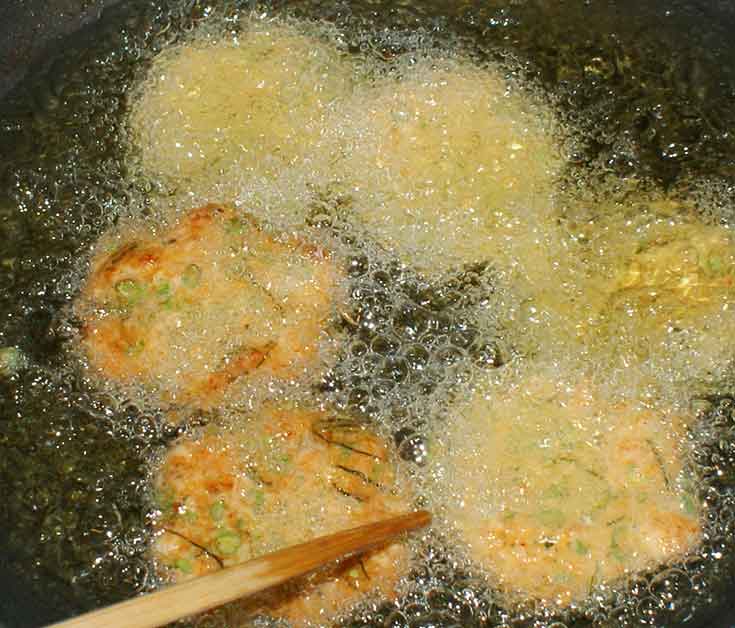 Cooking Thai fish cakes in wok.