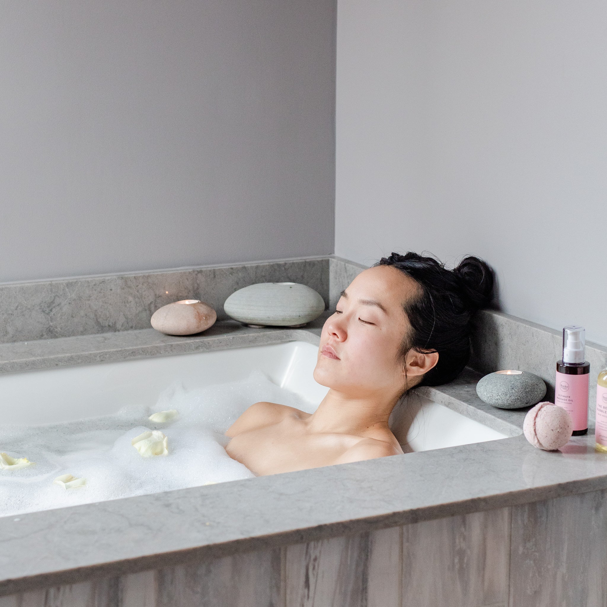 Woman relaxing in bath with natural rocky mountain soap massage oil. 